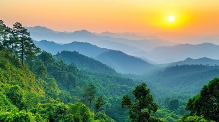 Fototapeta premium Overlooking Green Mountain Range at Sunset with Dramatic Orange Sky