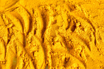 Dry ground food spice turmeric. Texture pattern. Close-up.