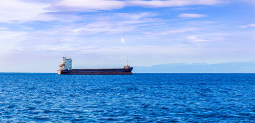 Fototapeta premium Oil tanker underway towards open sea. Crude oil tanker ship, a merchant ship specially designed for chemical products transportation