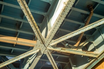 Rivets connecting steel girders underneath bridge structure