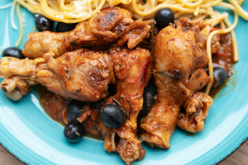 Chicken cacciatore with black olives, pepperoni, tomatoes, with italian spaghetti pasta. Italian food