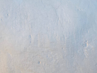 A close-up texture of a plastered wall with subtle cracks and rough details, showcasing an abstract background perfect for architectural and artistic design concepts