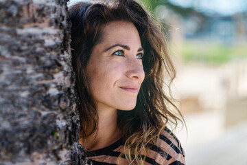 stock photo of woman behind tree