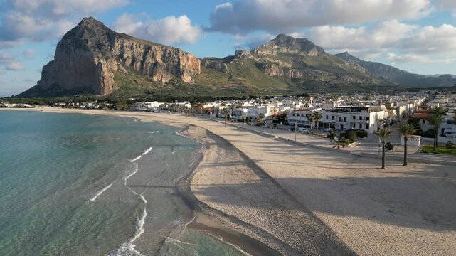 Italy Sicily travel and tourism, flying over beautiful beach of of San Vito Lo Capo town towards landscape of spectacular mountains
