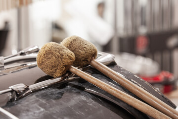 Close-up of drum beaters lying on a bass drum