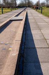 Water channel flowing along pathway in park