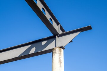 Steel girders forming framework against blue sky