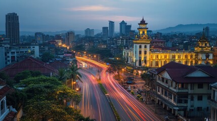 Fototapeta premium Aerial view of the city at dusk with illuminated buildings and roads