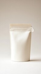 Minimalist studio shot of a white vertical package with subtle texture on a light beige background capturing simplicity