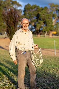 man holding electrical extension cord like a lasso