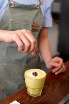 Chai and turmeric tea latte prepared on table in cafe