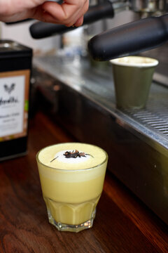 Chai and turmeric latte being prepared in cafe kitchen