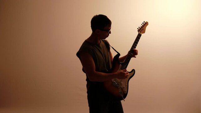 silhueta de homem guitarrista tocando guitarra eletrica 