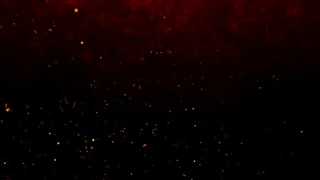 Fiery orange glowing flying ember particles on black background. Burning red hot sparks rise from light fire loop background of bonfire.