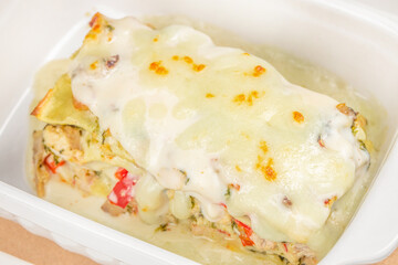 Homemade delicious chicken mushroom spinach lasagna in a baking dish
