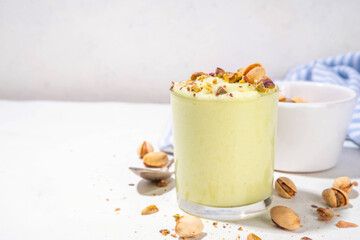 Vegan alternative non-dairy pistachio heavy cream, pistachio pudding or yogurt, with crushed pistachio nuts, copy space