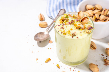 Vegan alternative non-dairy pistachio heavy cream, pistachio pudding or yogurt, with crushed pistachio nuts, copy space