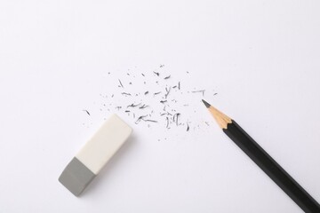Eraser, pencil and scraps on paper, flat lay