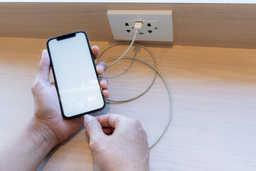 Smart phone charging,plugged into electrical outlet