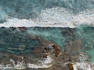 Waves crashing on the coral reefs in Uluwatu, Bali