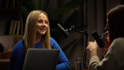 Two Influencers of women being interviewed in a loft-style podcast studio