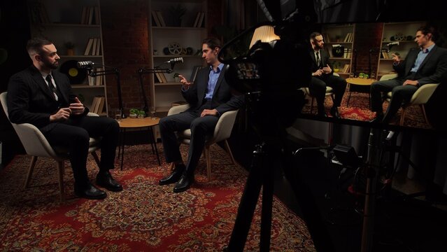 Two experts talking in a cozy, loft-style podcast studio