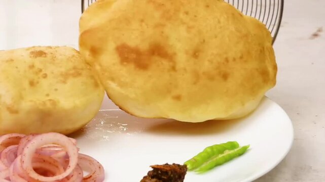 Chole Bhature &ndash; A famous North Indian street food with spicy chickpea curry (Chole) and crispy deep-fried bread (Bhature). Indians favorite, loved in restaurants, homes, and street food stalls.