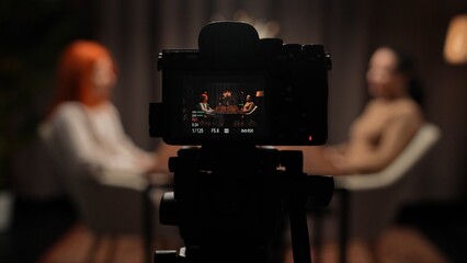 Two Influencers of women being interviewed in a loft-style podcast studio