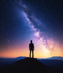 Fototapeta premium Starry Contemplation: A solitary figure stands atop a mountain peak, silhouetted against a breathtaking panorama of the Milky Way and the night sky. Evoking feelings of awe, wonder, and solitude.