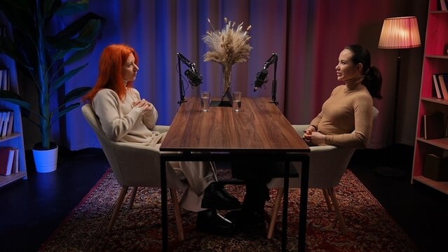 Two Influencers of women being interviewed in a loft-style podcast studio