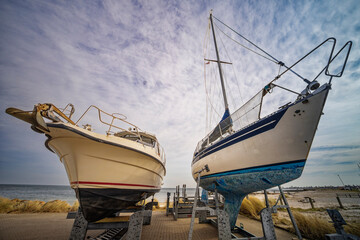 Two Sailboats in a Harbor Dry Dock Under a Cloudy Sky, Juelsminde, Denmark