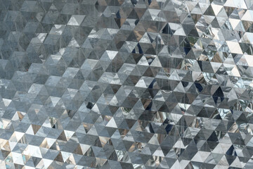 Close-up of gray metal roof panels with light reflections. Abstract background.