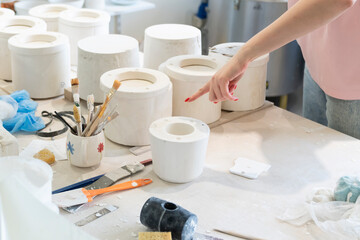A young woman makes ceramics in her own workshop