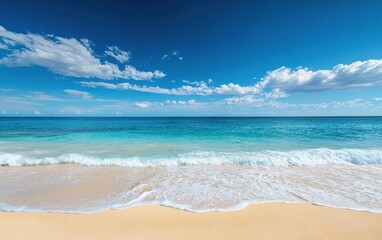 A serene beach with turquoise water and gentle waves, under a bright blue sky