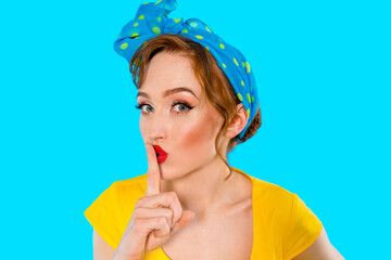 Woman in yellow top and blue polka dot headscarf poses playfully with finger on lips against bright blue background