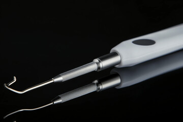 A dental tool with a sharp hook tip, used in medical or dental practices, on a black reflective surface showing high-quality details.