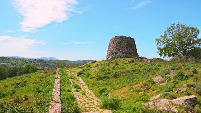 Nuraghe Su Nuraxi 'e Pauli in Seulo, Sardinia historic ancient ruins of stone rock wall tower with fence in Seulu, Italy