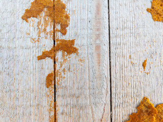 Weathered white wood with rustic orange stains texture as background