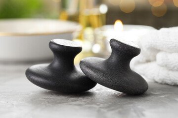Massage stones on grey background, closeup. Spa treatment
