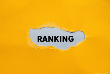 Ranking message written on ripped torn yellow paper on gray background. Conceptual ranking symbol....