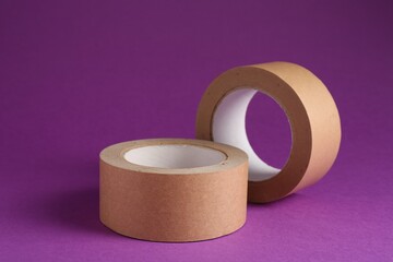 Rolls of masking tapes on violet background