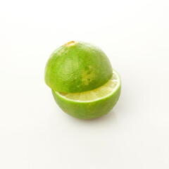 Isolated in White Background, Fresh Green Lime Halved to Reveal Juicy Interior and Vibrant Color