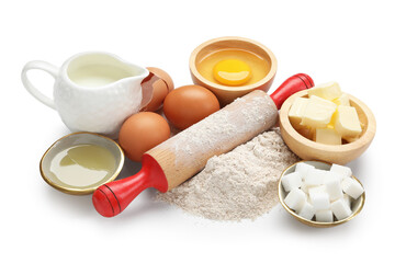 Rolling pin and different ingredients isolated on white