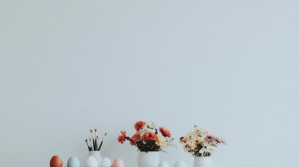 Creative pastel egg painting station for Easter festivities featuring vibrant paint bottles, brushes, and white eggs ready for decoration