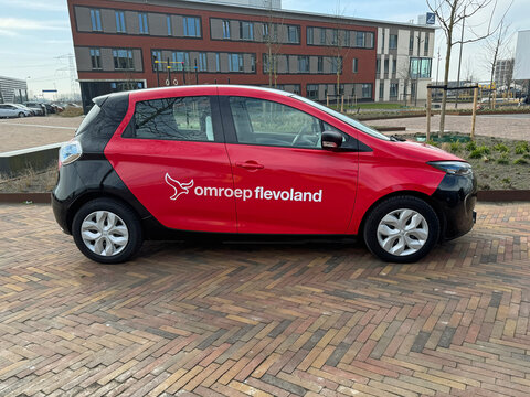 Almere, the Netherlands - March 6, 2025: Regional broadcaster (Omroep Flevoland) car parked on a public square. Nobody in the vehicle. 