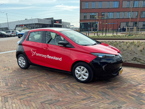 Almere, the Netherlands - March 6, 2025: Regional broadcaster (Omroep Flevoland) car parked on a public square. Nobody in the vehicle. 