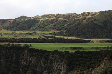New Zealand Landscape with Grasslands, Mountains, and Cliffs