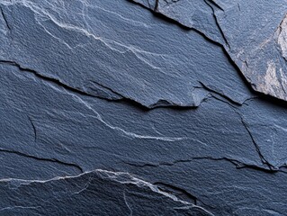 Dark blue slate wall with rough and grainy texture creating a unique and artistic background setting
