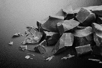 Dark sweet tasty chocolate bar on table