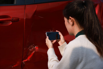 Drivers use mobile phones and tablets to take photos of car crashes for insurance claims due to road accidents. Drivers Involved In Car Accident Taking Pictures Of Damage And Calling Insurance Company